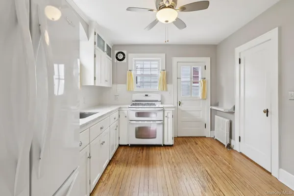 a kitchen with stainless steel appliances a white stove top oven and a refrigerator
