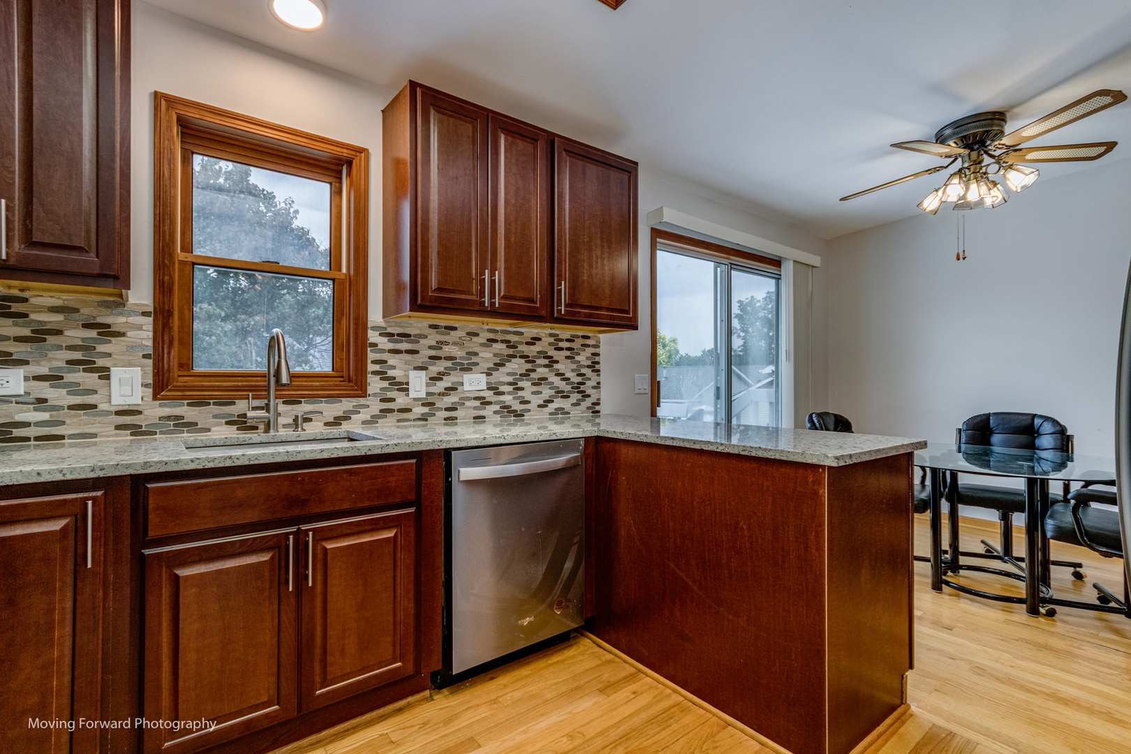 37 Evergreen Road Streamwood, IL 60107 - Photo 12 of 36 a kitchen with granite countertop wooden cabinets a sink a window and stainless steel appliances
