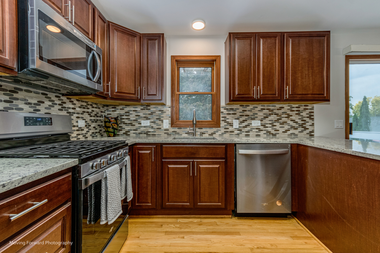 37 Evergreen Road Streamwood, IL 60107 - Photo 13 of 36 a kitchen with stainless steel appliances granite countertop a stove a sink and a microwave