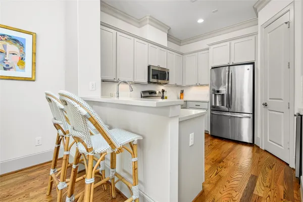 a kitchen with stainless steel appliances a refrigerator and a stove top oven