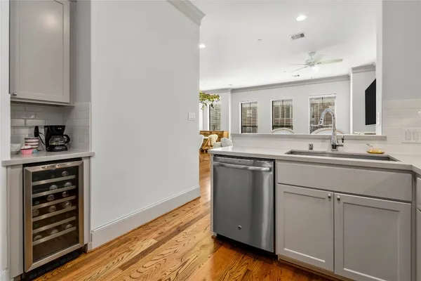 a kitchen with a sink cabinets and wooden floor