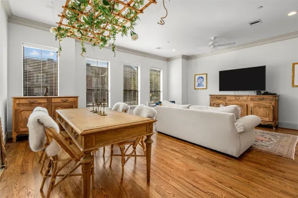 a dining room with furniture and wooden floor