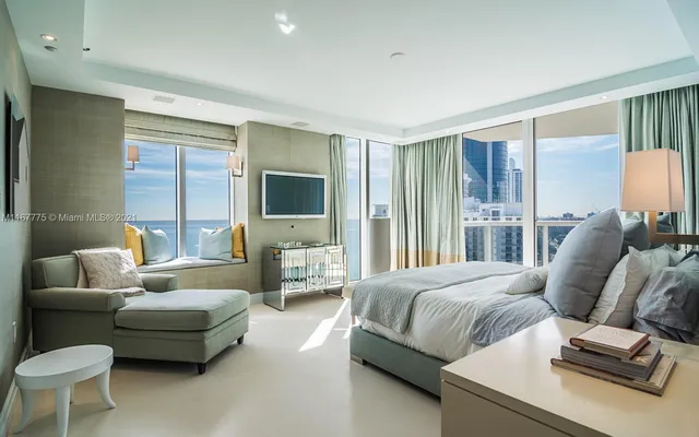 a bedroom with a bed and glass window