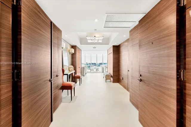 a view of a hallway with furniture and entryway