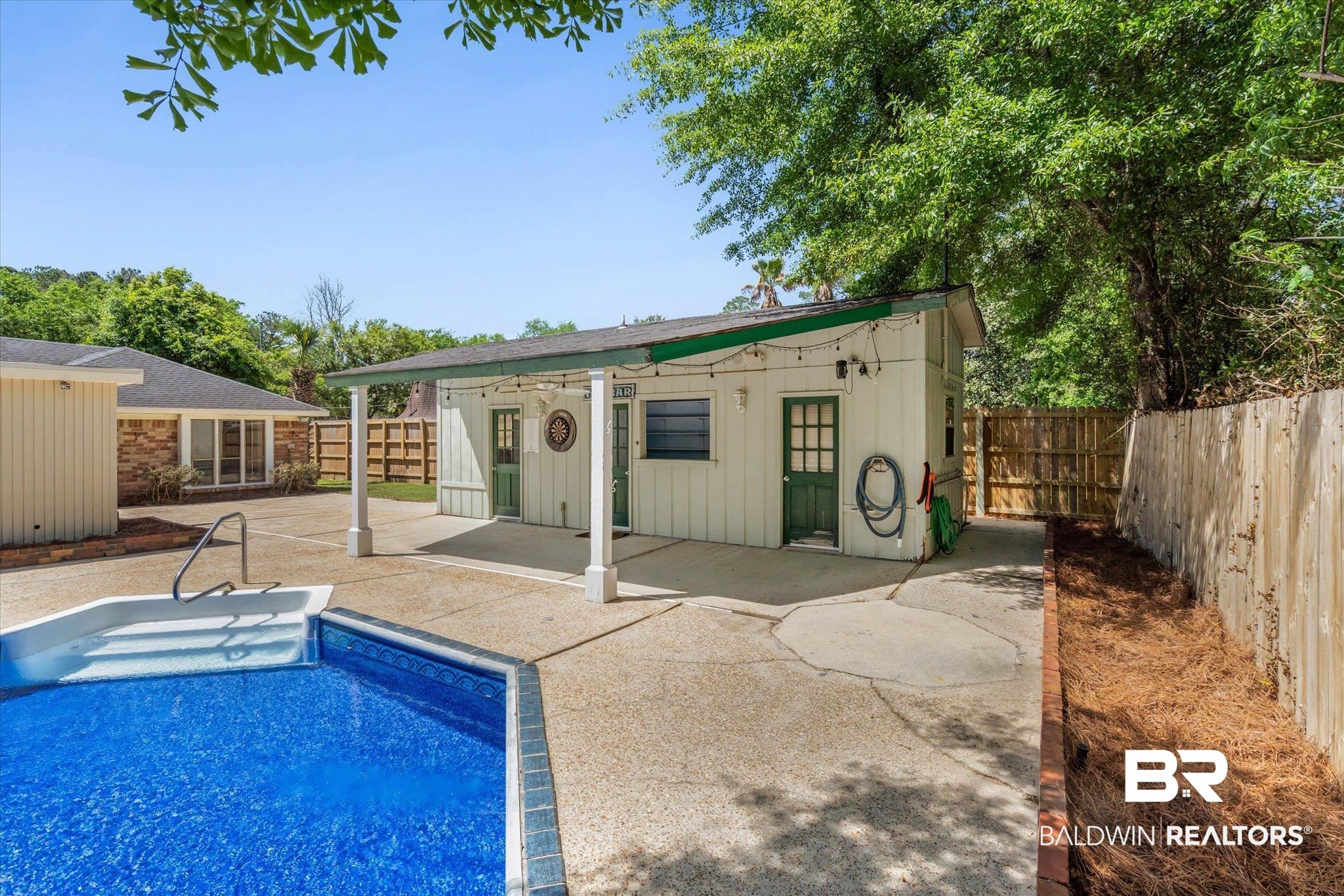 3724 Claridge Road South Mobile, AL 36608 - Photo 32 of 42 View of pool featuring an outdoor structure, a fenced backyard, a storage structure, and patio surround