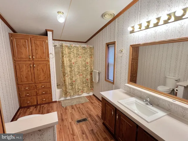 a bathroom with a sink a mirror and a shower