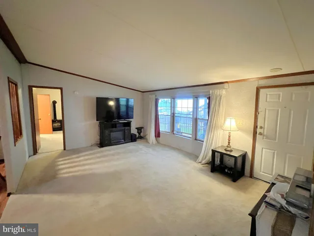 a large bedroom with a bed and furniture