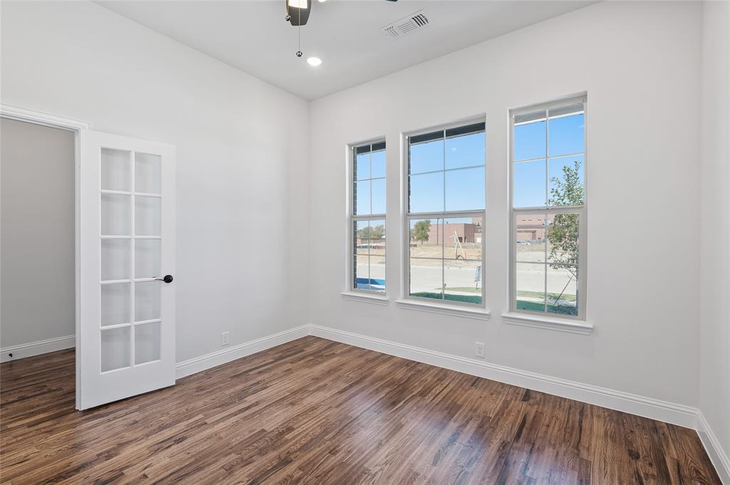 613 Brazos Drive Van Alstyne, TX 75495 - Photo 7 of 29 Unfurnished room featuring dark wood finished floors, ceiling fan, and recessed lighting