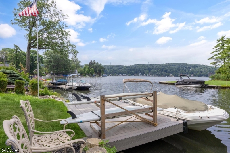 a view of a lake with couches and table
