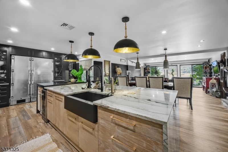 590 West Shore Trail Sparta, NJ 07871 - Photo 11 of 41 a kitchen with stainless steel appliances granite countertop a sink and a refrigerator