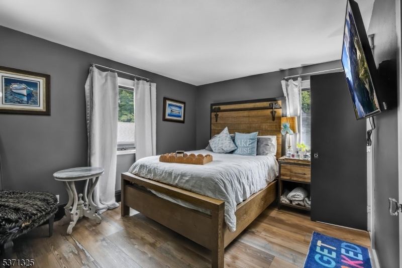 590 West Shore Trail Sparta, NJ 07871 - Photo 17 of 41 a bed sitting in a bedroom next to a window