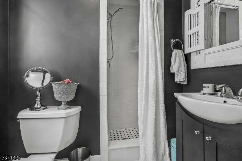 590 West Shore Trail Sparta, NJ 07871 - Photo 19 of 41 a bathroom with a toilet a sink and mirror