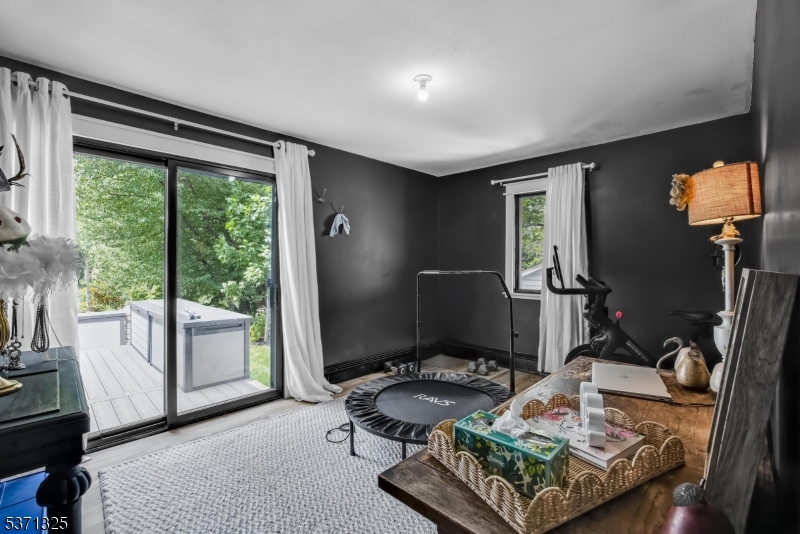 590 West Shore Trail Sparta, NJ 07871 - Photo 20 of 41 a living room with furniture and a floor to ceiling window