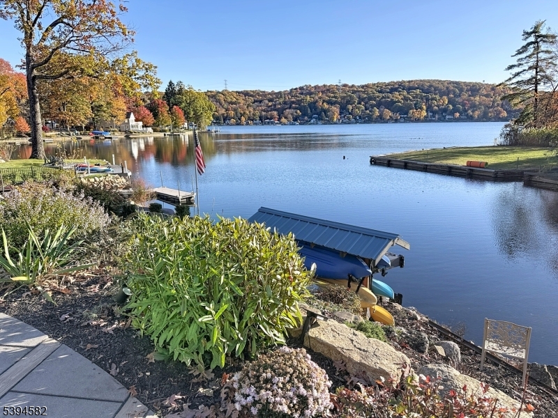 590 West Shore Trail Sparta, NJ 07871 - Photo 2 of 41 a view of a lake with a house in the background