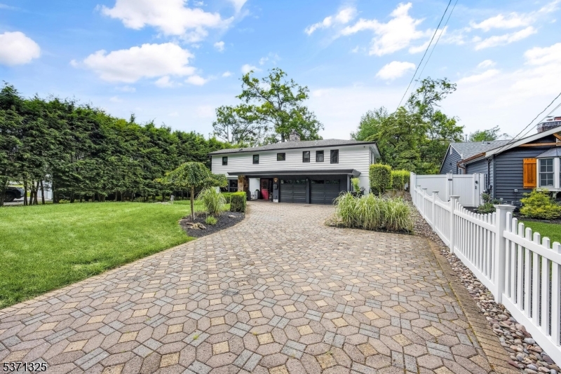 590 West Shore Trail Sparta, NJ 07871 - Photo 40 of 41 a front view of a house with a yard and potted plants