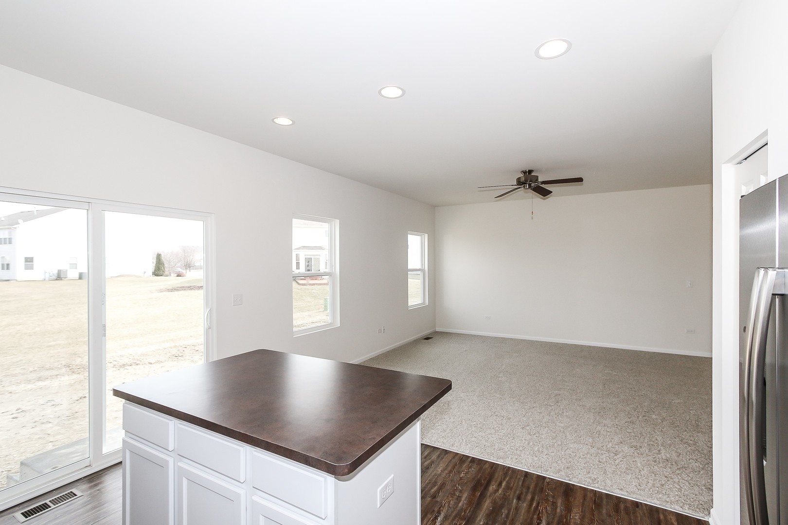 904 Sharp Drive, Unit 1593 Plano, IL 60545 - Photo 24 of 39 a kitchen with a sink a window and cabinets