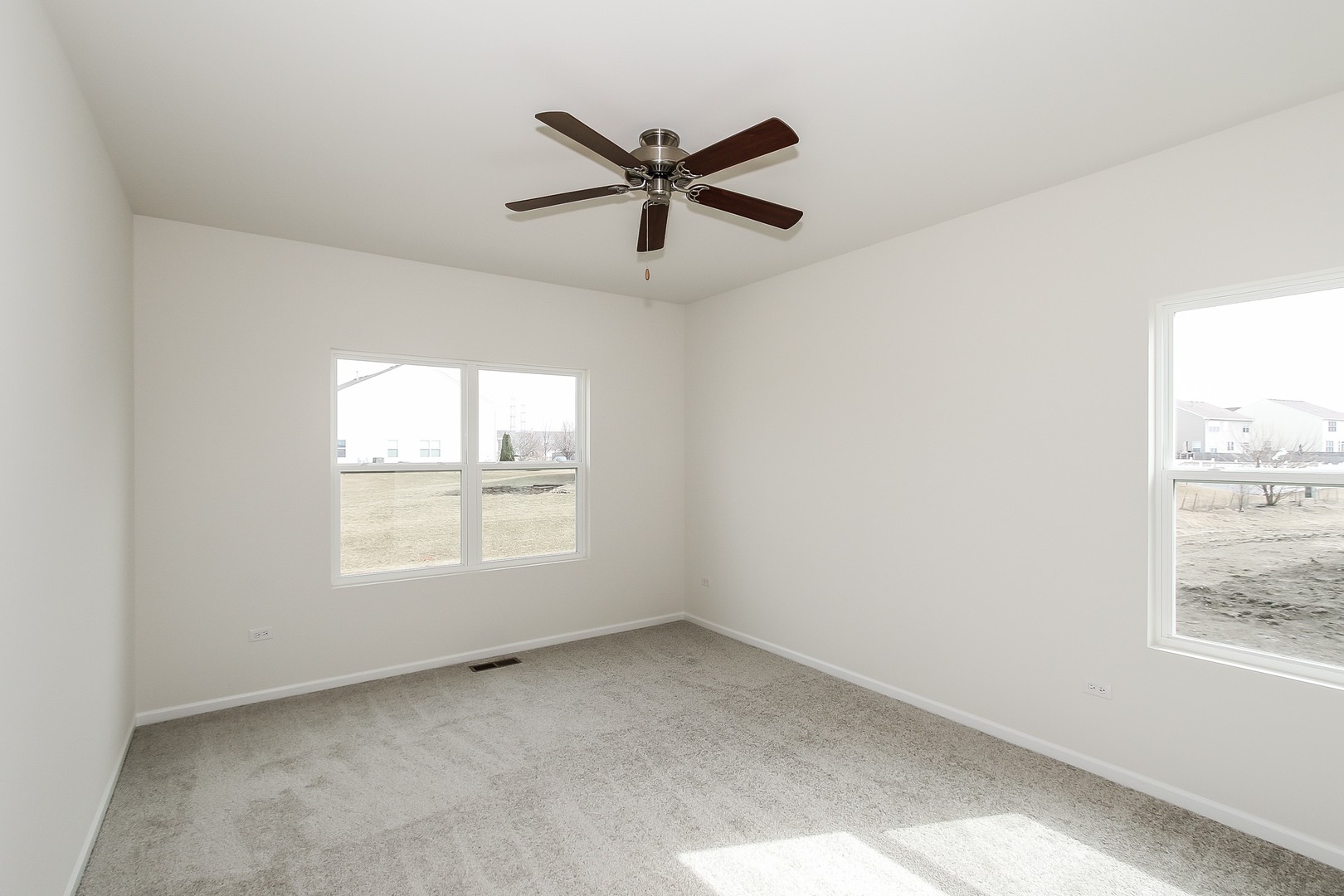 904 Sharp Drive, Unit 1593 Plano, IL 60545 - Photo 25 of 39 a view of a livingroom with a ceiling fan and window