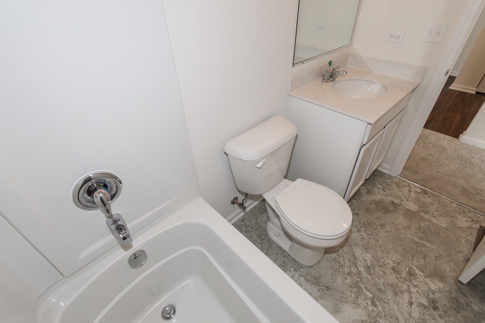 904 Sharp Drive, Unit 1593 Plano, IL 60545 - Photo 36 of 39 a white toilet sitting next to a bathroom sink