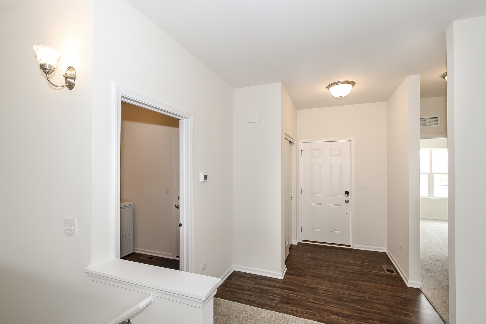904 Sharp Drive, Unit 1593 Plano, IL 60545 - Photo 4 of 39 a view of a hallway to rooms