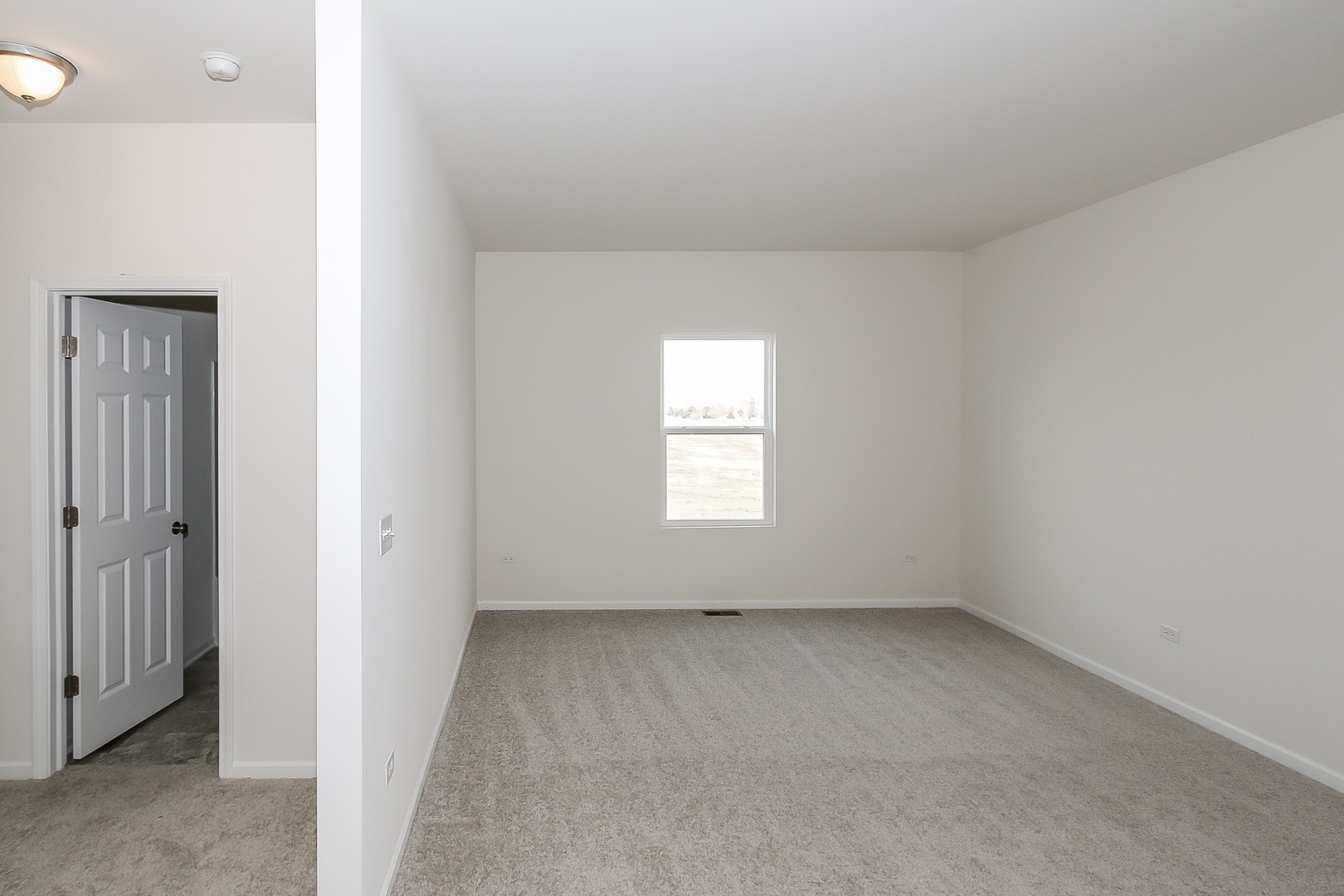 904 Sharp Drive, Unit 1593 Plano, IL 60545 - Photo 6 of 39 an empty room with a window