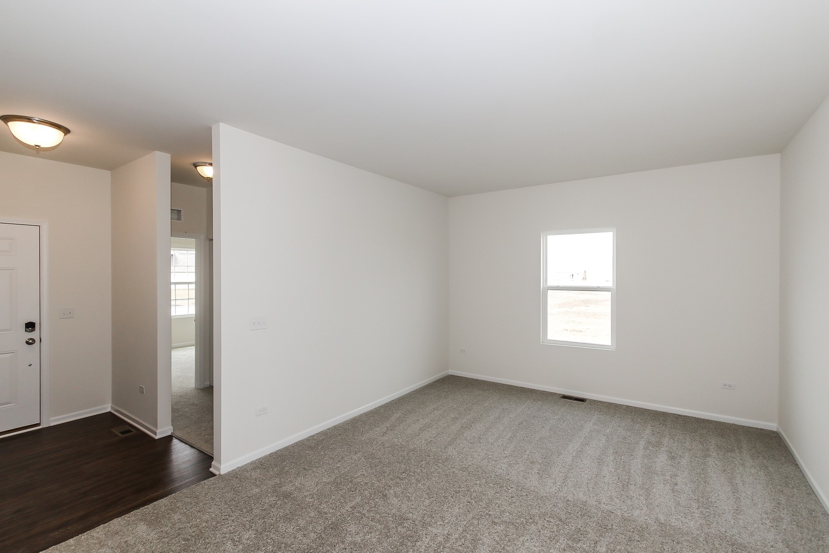 904 Sharp Drive, Unit 1593 Plano, IL 60545 - Photo 8 of 39 a view of an empty room with a window