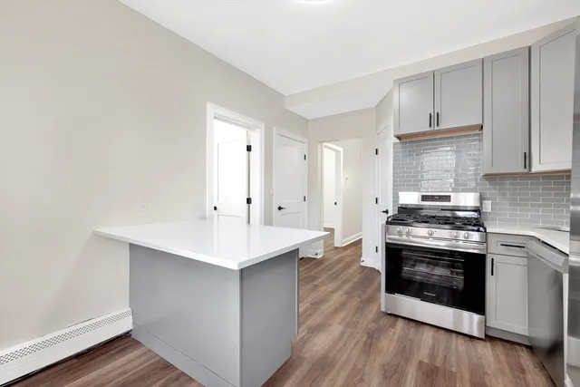 a kitchen with stainless steel appliances white cabinets and sink