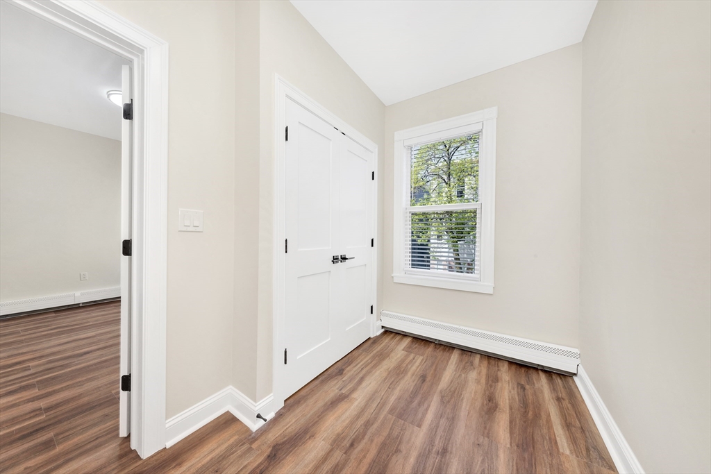 16 O Street, Unit 2 Boston, MA 02127 - Photo 7 of 19 a view of an empty room with wooden floor and a window