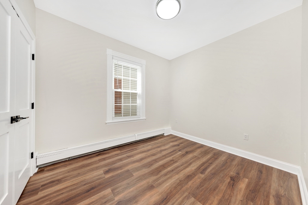 16 O Street, Unit 2 Boston, MA 02127 - Photo 8 of 19 a view of a room with wooden floor and white walls