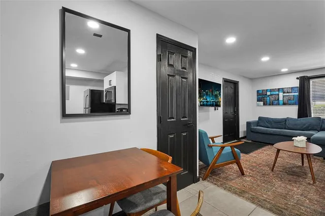 a bathroom with a sink a toilet a mirror and shower curtain
