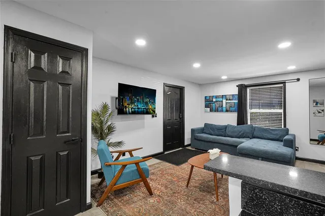a kitchen with stainless steel appliances granite countertop a table and chairs in it