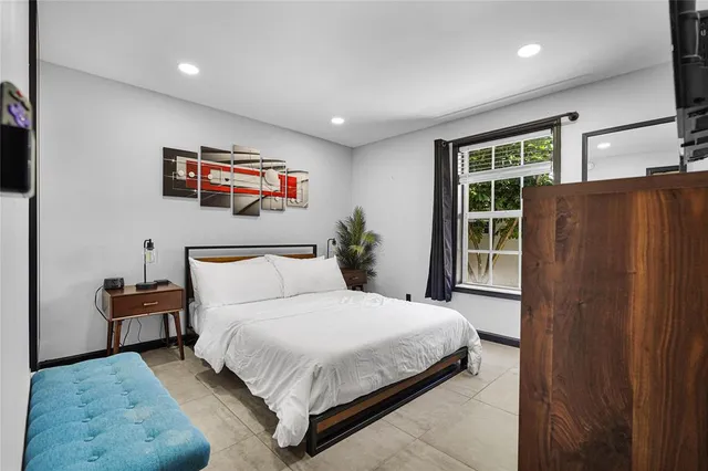 a bathroom with a granite countertop sink toilet and mirror