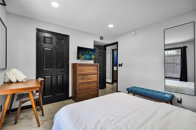 a bedroom with a bed and a desk