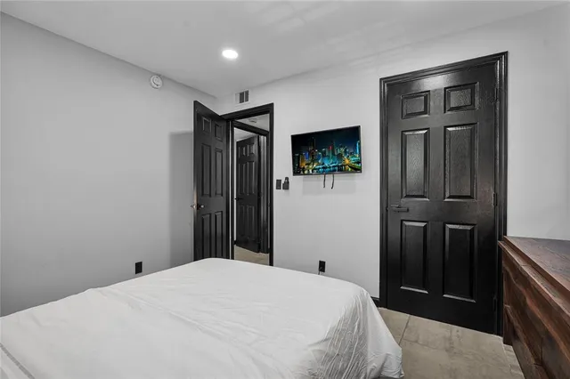 a bedroom with a bed and a table in it