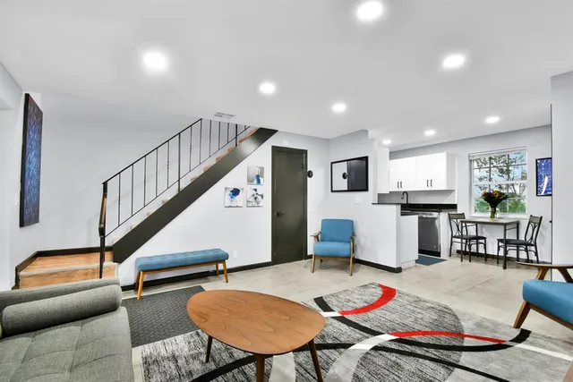 a living room with furniture and a rug