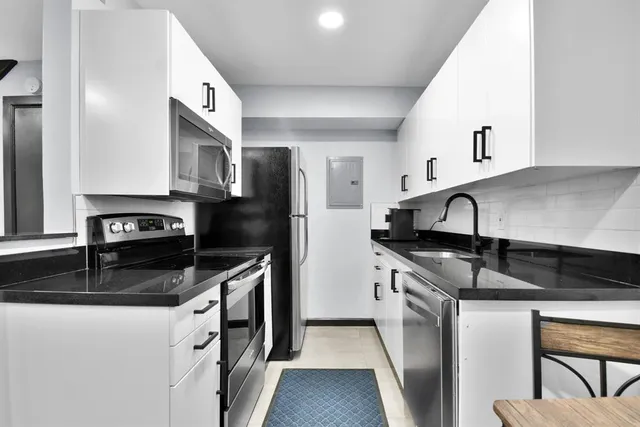 a living room with furniture and stairs