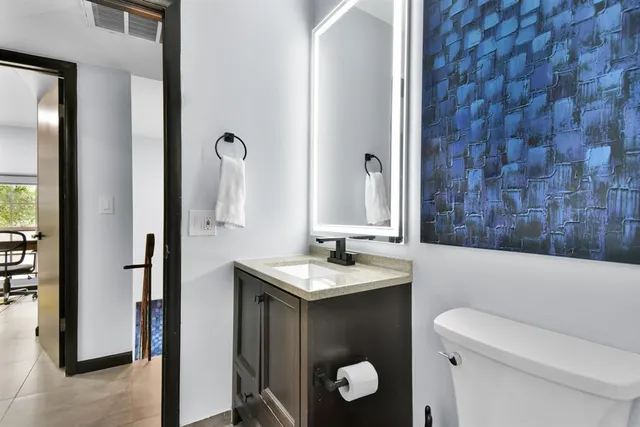 a bedroom with a bed and large windows