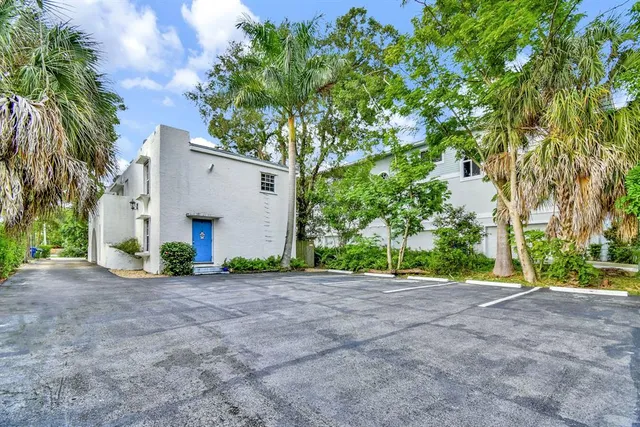 a living room with furniture and a dining table with kitchen view