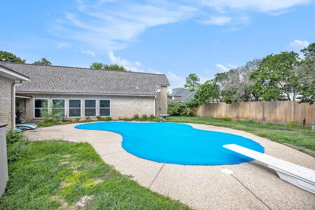 a view of pool with outdoor seating and yard