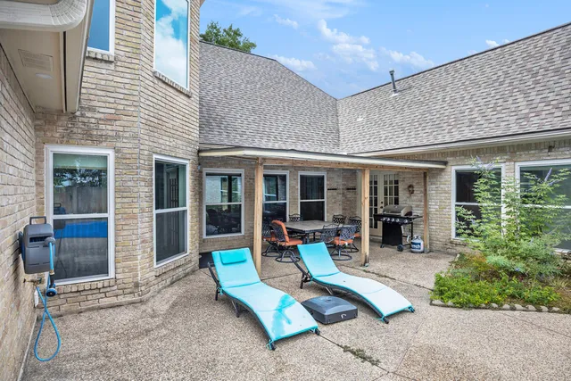 a view of a house with outdoor seating area and garden