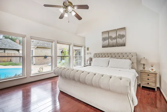 a spacious bedroom with a large bed and a large window