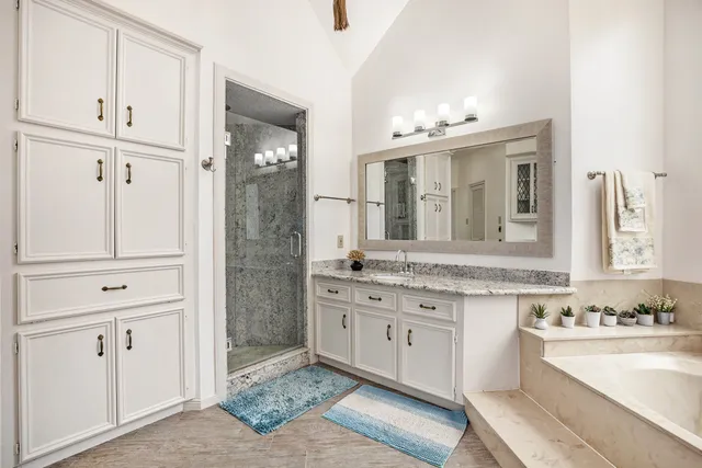 a bathroom with a granite countertop sink mirror and double