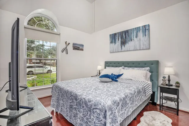 a bedroom with a bed and a window