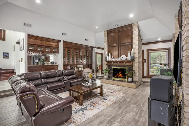 a living room with furniture large window and a fireplace