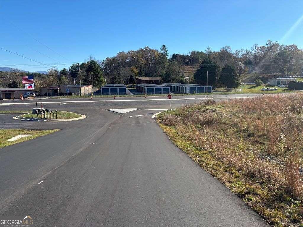 1 Windy Ridge Lane Hayesville, NC 28904 - Photo 6 of 26 a view of swimming pool with outdoor seating and trees in the background