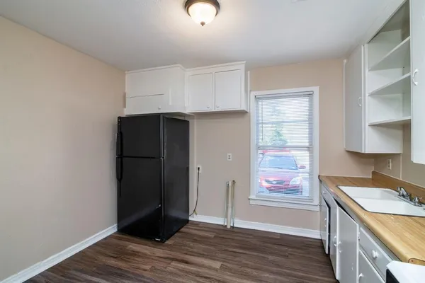 a kitchen with a refrigerator and a stove