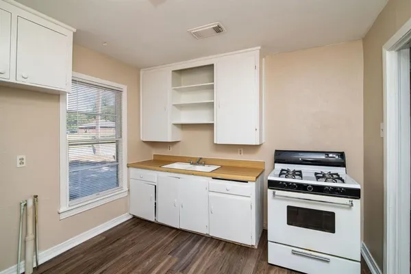 a kitchen with cabinets and white appliances
