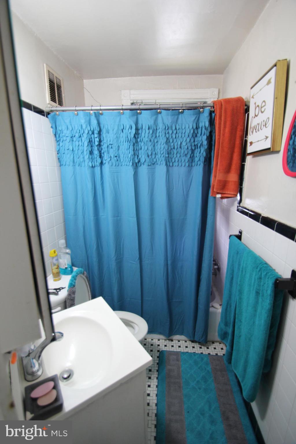5747 Belmar Street Philadelphia, PA 19143 - Photo 11 of 13 a bathroom with a sink and a mirror