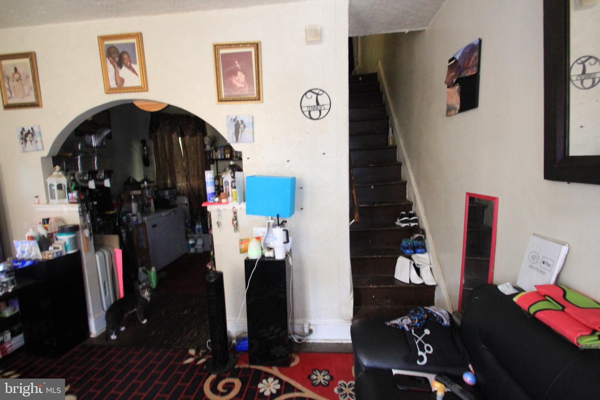 5747 Belmar Street Philadelphia, PA 19143 - Photo 2 of 13 a living room with furniture and a fireplace