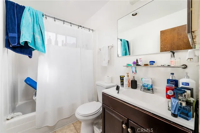 a bathroom with a sink a toilet and a shower curtain