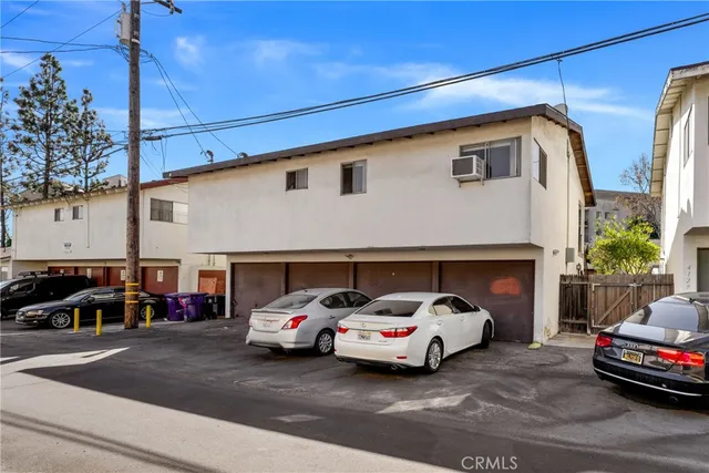 a car parked in front of a white house
